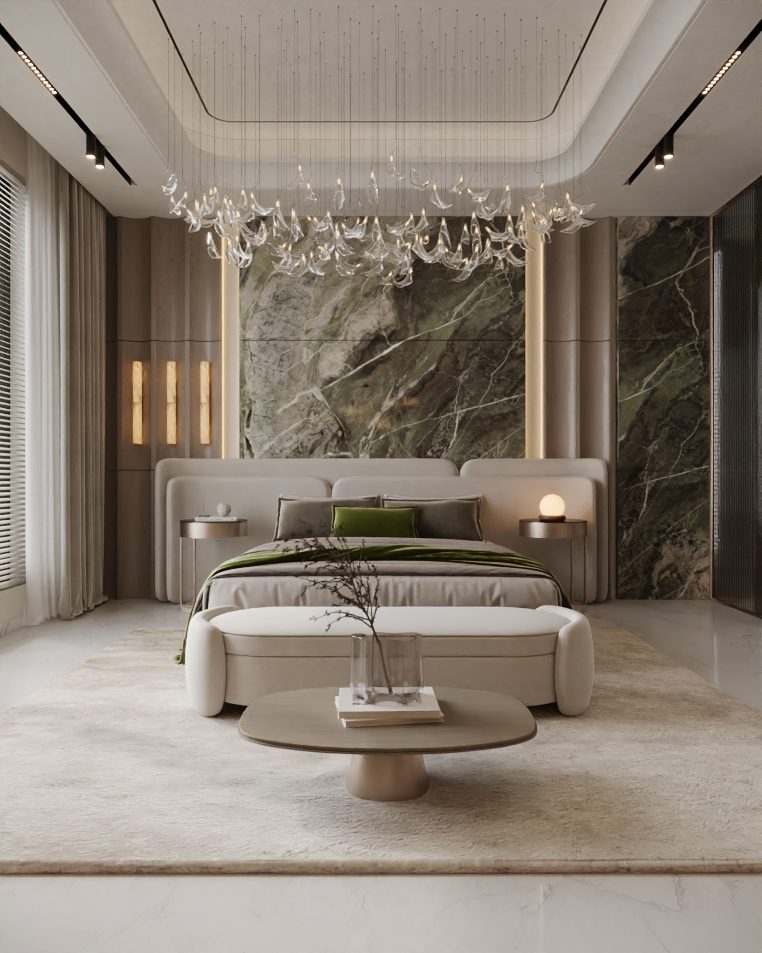 Bedroom with a curved upholstered bed, green throw and marble feature wall